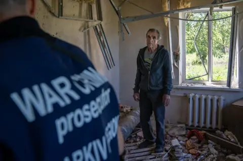 BBC Vadym Bobaryntsev in his home in Mala Rohan, after it was destroyed by a shell in the middle of March