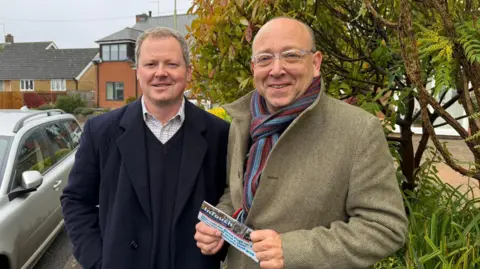 Two men in coats in the street