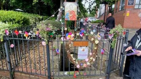 Steve Ramsden St Alkmund's Well in Derby decorated with flowers and pictures.