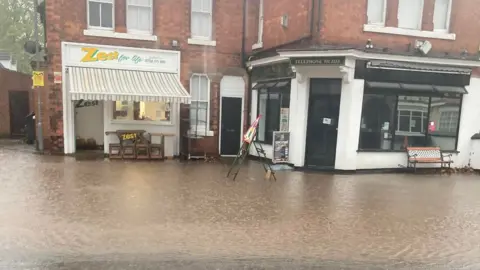 Niki Papachristodoulou Floods of water outside Zest for Life and Burton Joyce Fish Bar