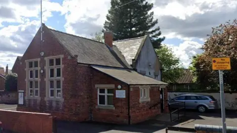 Google Hatfield Town Council building - a red brick building with a slanting roof and a car park.