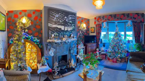 Geoff Stonebanks A room adorned with loads of Christmas decorations. 