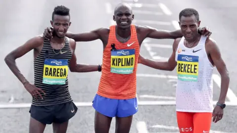 PA Media Male race runners Barega, Kiplimo and Bekele pose for a picture together after finishing the run