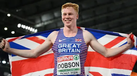 Charlie Dobson celebrates with a British flag