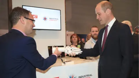 PA The Duke of Cambridge shakes hands with a robotic hand made by a 3D printer during a visit to the International Business Festival at the Exhibition Centre Liverpool