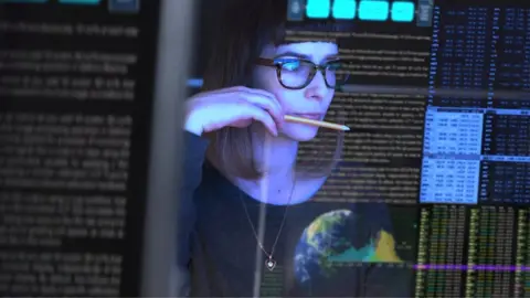 Getty Images Woman looks at data