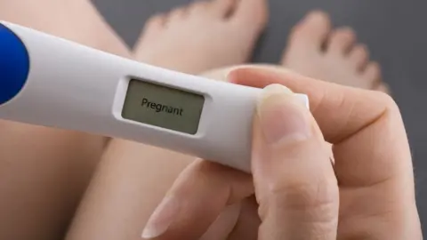 Getty Images pregnancy test showing woman is pregnant