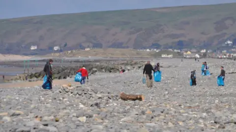 Surfers Against Sewage Several beach cleaners on Borth beach