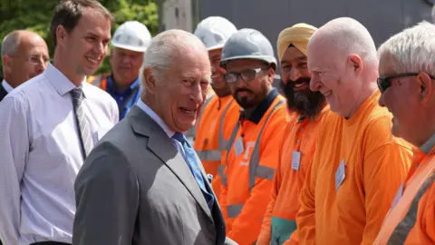 PA Media King Charles III meets construction workers during a visit to the Thames Tideway Tunnel