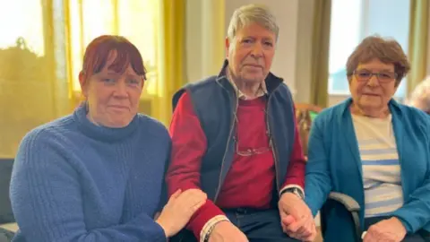 Joan and Simon Lee with carer Emma