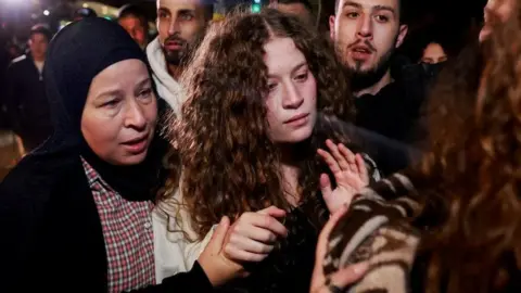 Reuters Palestinian activist Ahed Tamimi is pictured with her mother after being returned to the West Bank