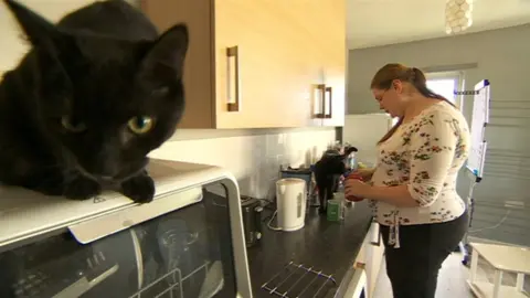 Lucy Tilley making a drink in the kitchen