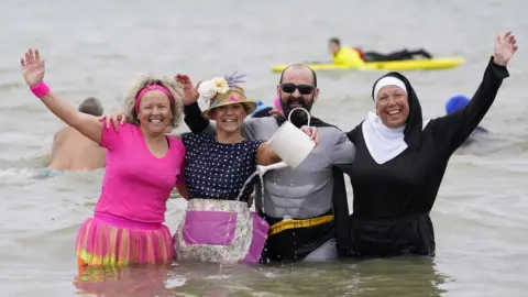 PA Media Gosport swimmers in fancy dress on New Year's Day