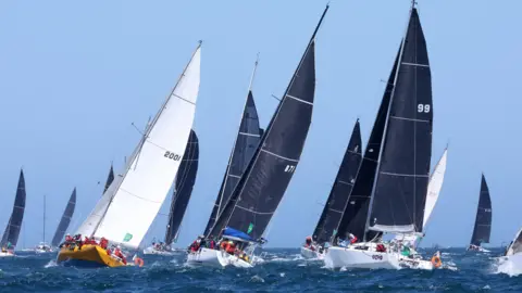 EPA The fleet sails out of the Sydney Heads during the 2024 Sydney Hobart Yacht Race in Sydney