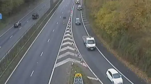 A traffic camera view onto the M2, showing traffic travelling westbound, but the eastbound lanes empty of traffic