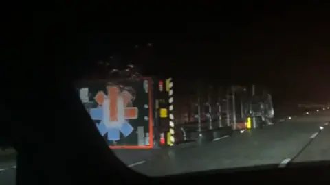 Owen Clanachan A lorry on its side on the M74 motorway