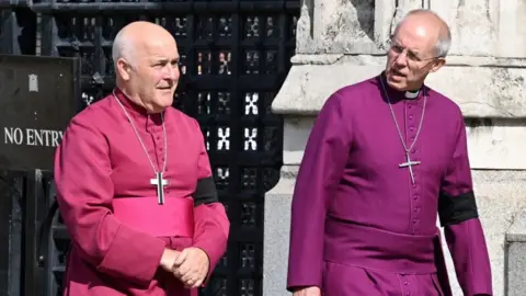 Reuters Archbishop of York Stephen Geoffrey Cottrell (L) and The Archbishop of Canterbury Justin Welby walk in central London on September 14, 2022, ahead of the ceremonial procession of the coffin of Queen Elizabeth II, from Buckingham Palace to Westminster Hall.