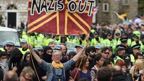Getty Images: Dan Kitwood Man holding a nazis out banner
