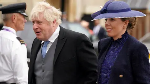 Reuters former prime minister Boris Johnson and his wife Carrie Johnson arriving at coronation ceremony of King Charles III