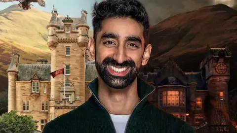 Kasim, a 33-year-old man. He has short black hair, curling on top,  a dark, neatly trimmed beard and is smiling broadly. He is wearing a black fleece over a white t-shirt. Behind him are hills rising to the sky and a stone Scottish baronial-style castle with creamy stone, a grey slate roof and turrets