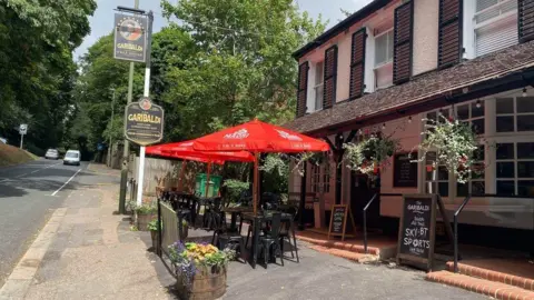 Supplied The outside of an English pub on a sunny day. 