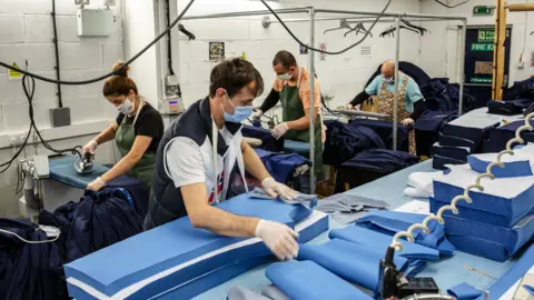 Getty Images Employees at 'Fashion Enter' in London make scrubs for NHS staff on April 24 2020