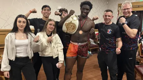 Divine with his coaches after becoming British Champion.