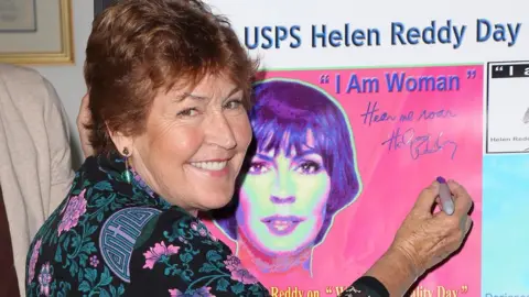 Getty Images Helen Reddy signing an I Am Woman poster in Hollywood in 2013
