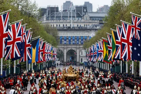 Clodagh Kilcoyne / Reuters King Charles and Queen Camilla travel in the Gold State Coach, following their coronation