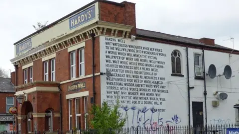 Gerald England  Hardy's Well pub with Lemn Sissay poem painted on the external wall