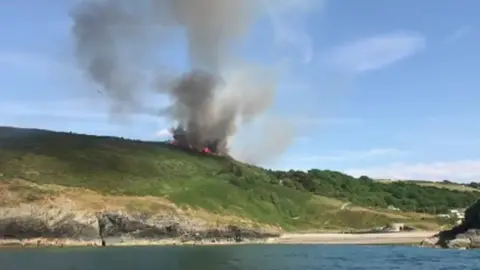 Rhys Boyle Fire on a hillside over Cwmtydu