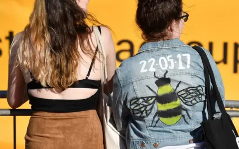 Getty Images Women at mass sing-along in Manchester