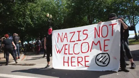 AFP Antifa protesters with a "Nazis not welcome here" banner