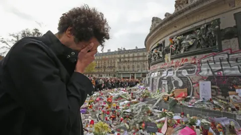 Getty Images A man weeps for a lost friend as people gather to observe a minute-silence at the Place de la Republique in memory of the victims of the Paris terror attacks last Friday, on November 16, 2015 in Paris