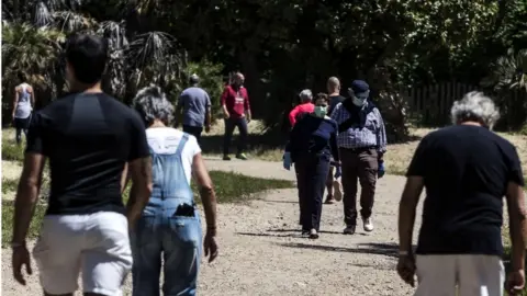 EPA People walk in the park of Villa Pamphili during phase two of the emergency block of the Coronavirus Covid-19 in Rome, Italy, 08 May 2020