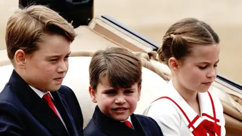 PA Media Prince George of Wales, Prince Louis of Wales and Princess Charlotte of Wales ride along in the carriage