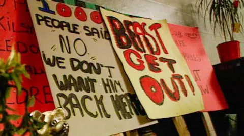 A screengrab of posters from the campaign to oust a child sex offender from the Raploch. The handmade banners read: "beast get out" and "1,000 people said 'no, we don't want him back here'".