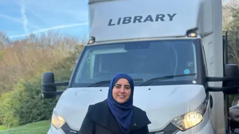 The council leader Neghat Khan stands in front of the mobile library