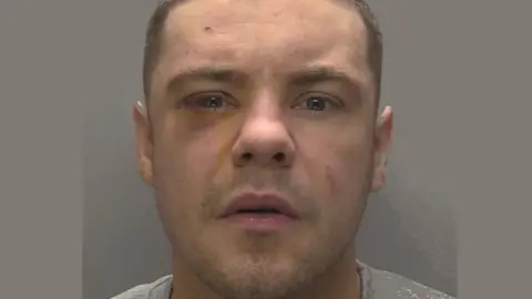 Humberside Police A police mugshot of Deven Huteson. He has short dark hair and is looking straight at the camera.