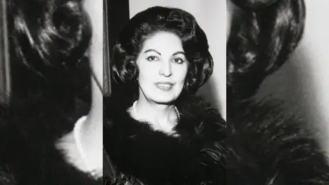 A black and white photo of Consuelo Velazquez in which she has dark curly hair.