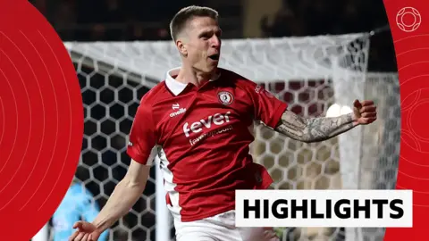 Emil Riis celebrates in front of goal in red Bristol City kit