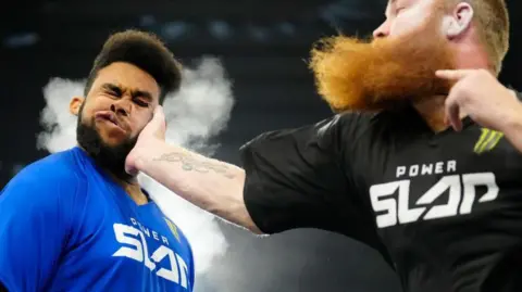 Icon Sportswire / Contributor Ron "Wolverine" Bata slaps Damien "The Bell" Dibbell in a 5-round bout. 