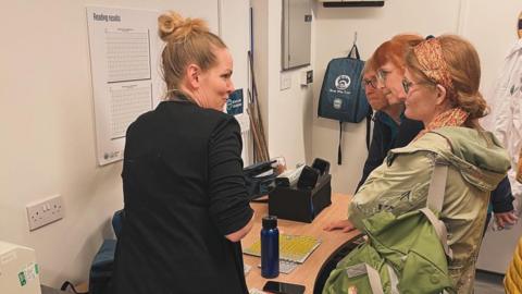 A Water Ranger volunteer showing members of the public how tests will be carried out at the new lab