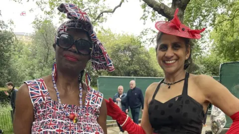 Two women are decked out in Union Jack memorabilia