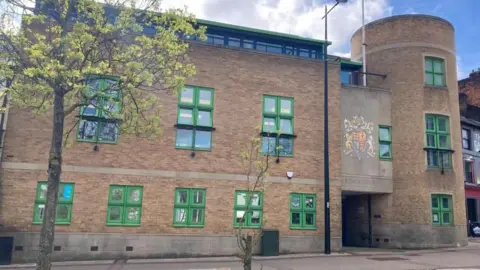 Brian Farmer/BBC Luton Crown Court: A brown-bricked building with green-framed windows. The words "CROWN COURT" are written over the entrance.