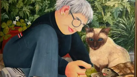 www.ourberylcook.com © John Cook 2025 A painting showing a woman wearing blue jeans a jumper with short hair and glasses. She is pictured with a cat and feeding leaves to tortoises