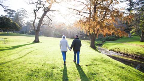 old couple walking in park