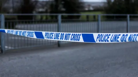 Police barrier tape in the UK - stock photo