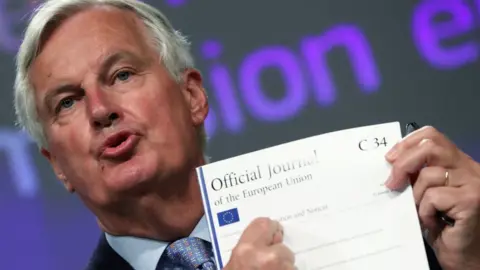 Reuters EU's Brexit negotiator Michel Barnier holding documents at a news conference after Brexit negotiations, in Brussels, Belgium, June 5, 2020