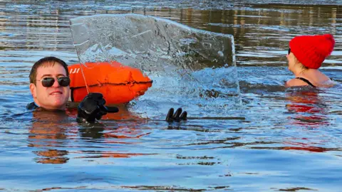 An image of a man holding a piece of ice at Spring Lakes